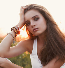 Load image into Gallery viewer, Close-up of a black-haired woman under a sunset